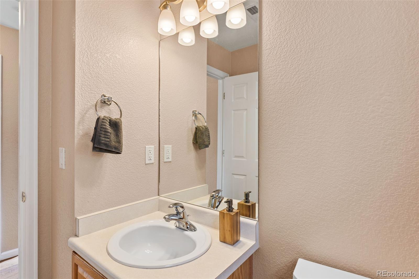 1189 Fall River Circle Longmont, CO 80504 - Photo 18 of 46 a bathroom with a sink and a mirror