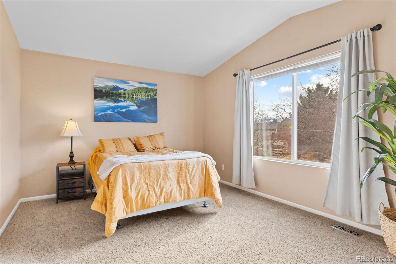 1189 Fall River Circle Longmont, CO 80504 - Photo 19 of 46 a bed sitting in a bedroom next to a window