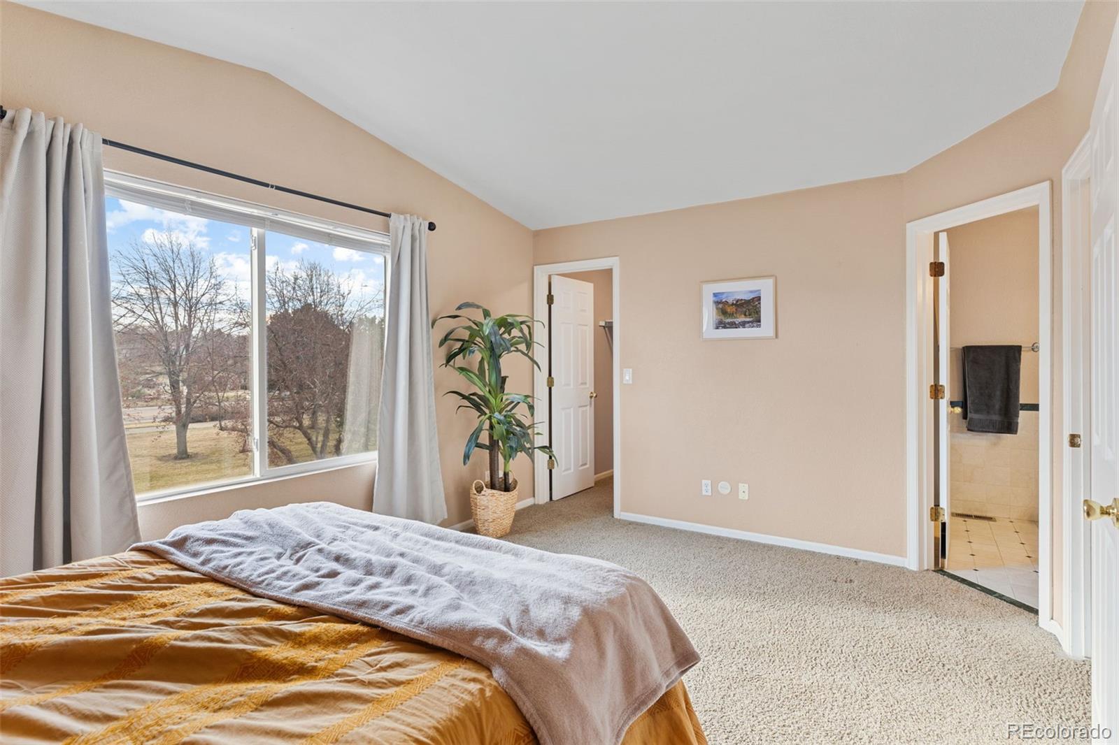 1189 Fall River Circle Longmont, CO 80504 - Photo 21 of 46 a bedroom with a bed and a large window
