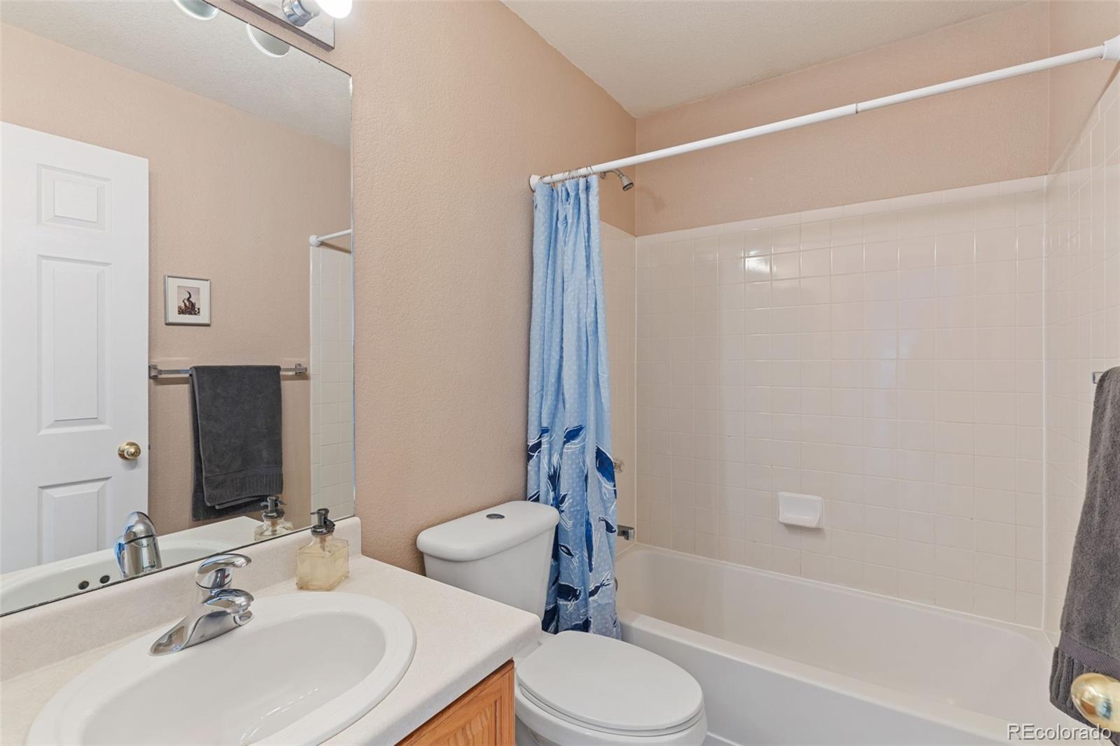 1189 Fall River Circle Longmont, CO 80504 - Photo 28 of 46 a bathroom with a sink toilet and shower