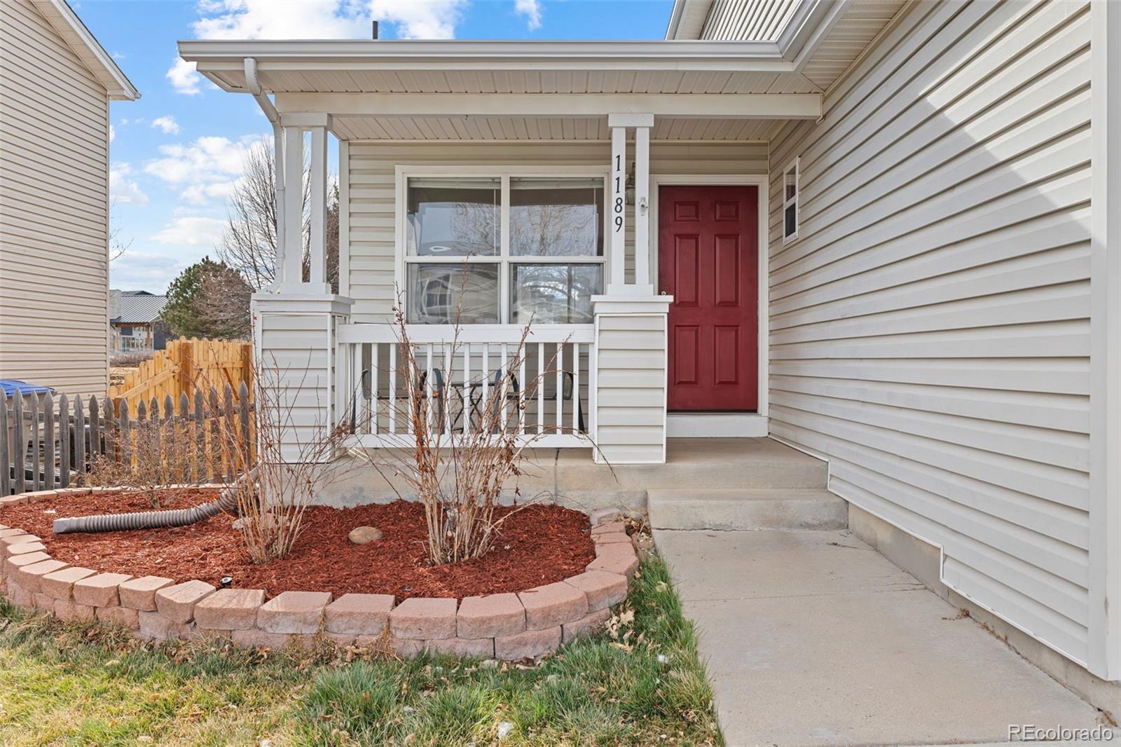 1189 Fall River Circle Longmont, CO 80504 - Photo 3 of 46 a front view of a house with a yard