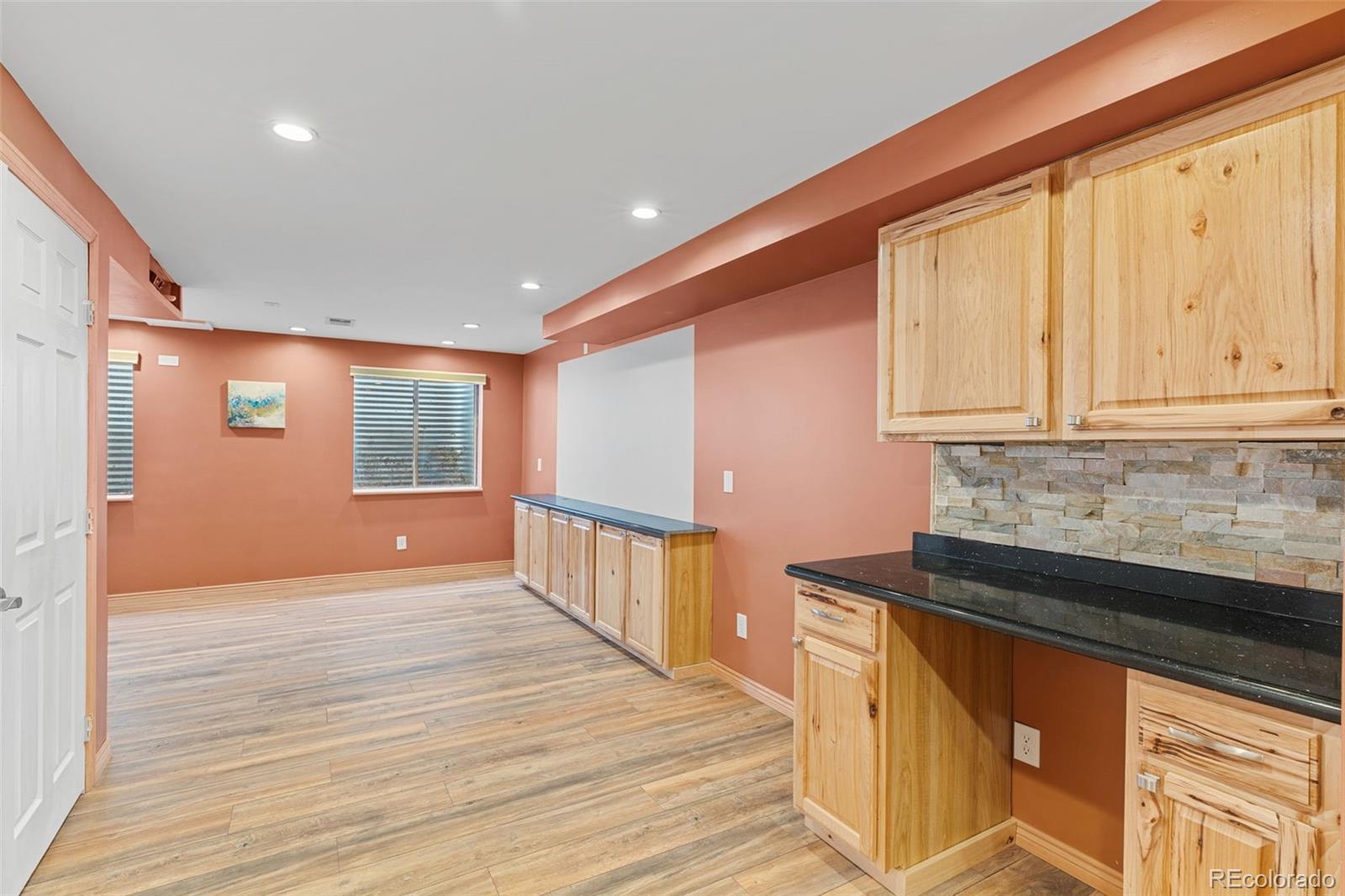 1189 Fall River Circle Longmont, CO 80504 - Photo 33 of 46 a view of a kitchen with wooden floor and staircase