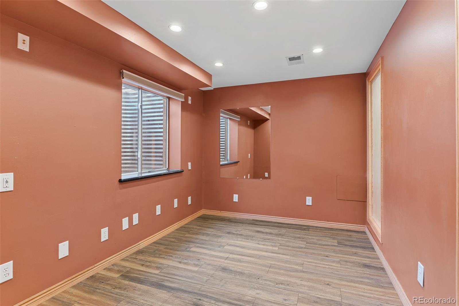 1189 Fall River Circle Longmont, CO 80504 - Photo 34 of 46 a view of empty room with wooden floor and fan