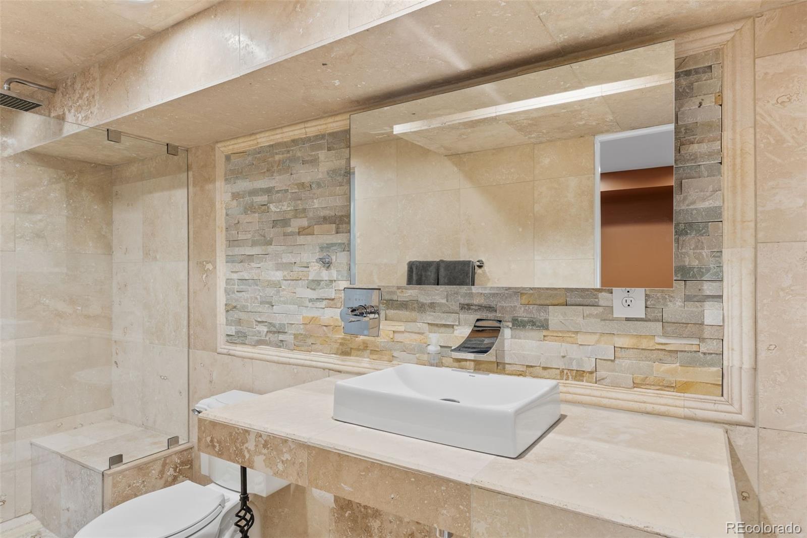 1189 Fall River Circle Longmont, CO 80504 - Photo 35 of 46 a bathroom with a granite countertop sink and a mirror