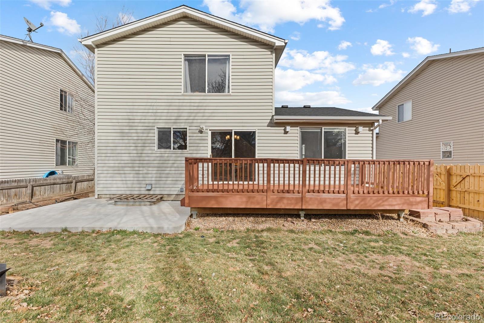 1189 Fall River Circle Longmont, CO 80504 - Photo 43 of 46 a view of a house with a yard and wooden fence