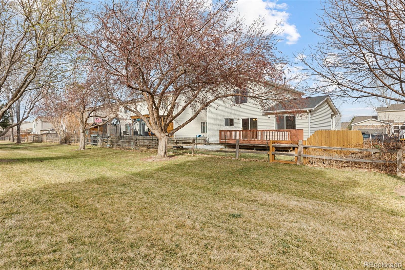 1189 Fall River Circle Longmont, CO 80504 - Photo 45 of 46 a house with trees in front of it