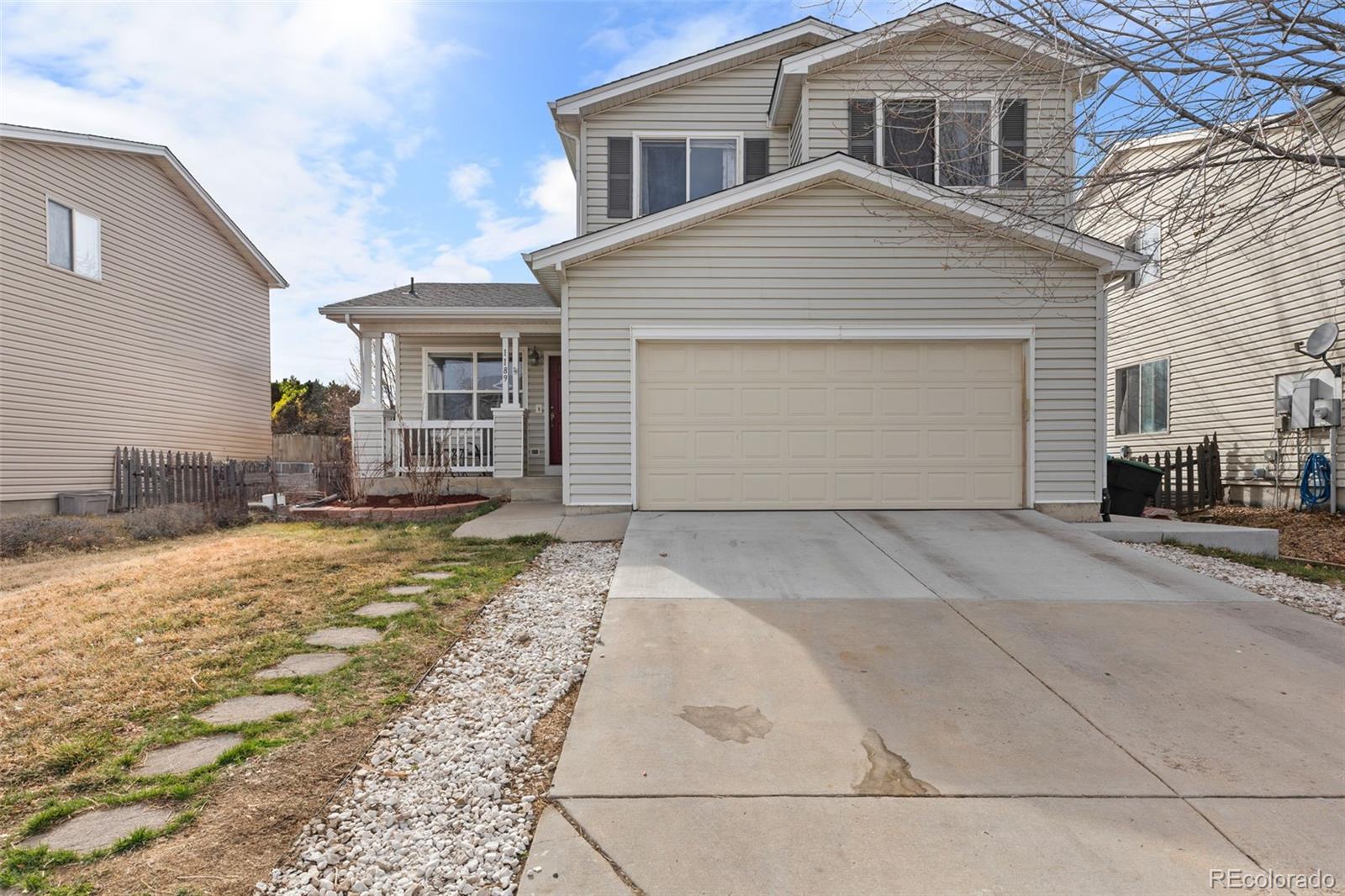 1189 Fall River Circle Longmont, CO 80504 - Photo 46 of 46 a front view of a house with a yard and garage
