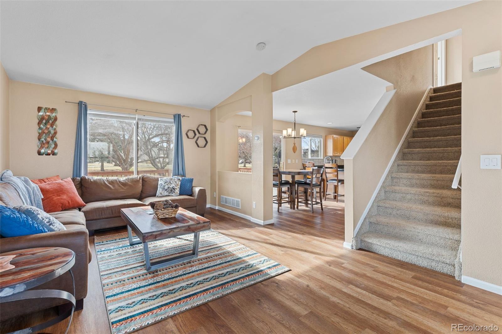 1189 Fall River Circle Longmont, CO 80504 - Photo 6 of 46 a living room with furniture and a wooden floor