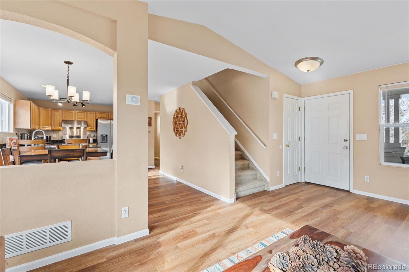 1189 Fall River Circle Longmont, CO 80504 - Photo 8 of 46 a view of a hallway with wooden floor and staircase