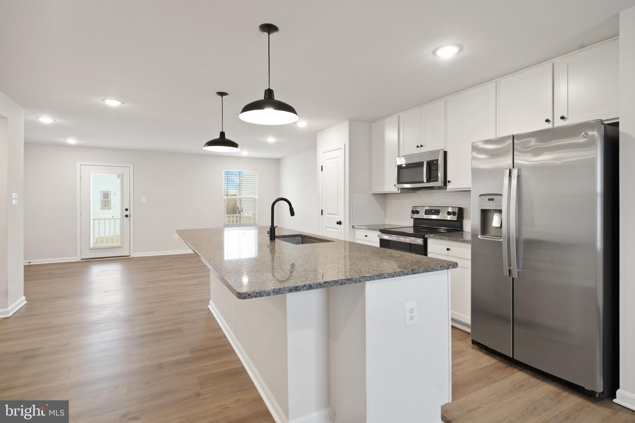 51 Thrower Road Hedgesville, WV 25427 - Photo 12 of 38 a kitchen with stainless steel appliances granite countertop a refrigerator a sink and a stove