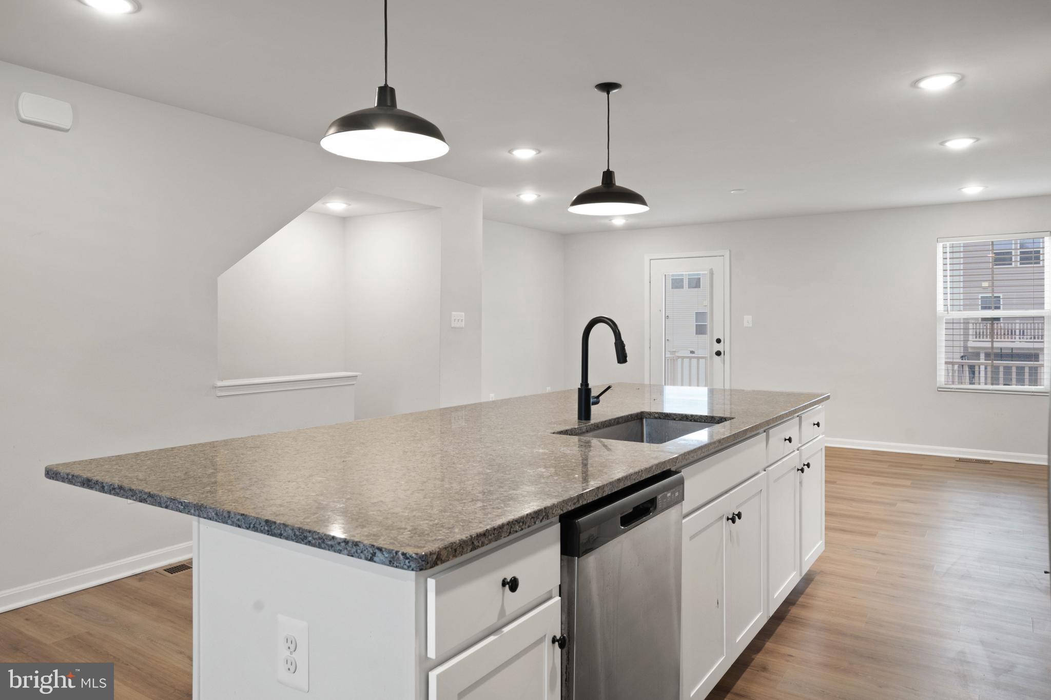 51 Thrower Road Hedgesville, WV 25427 - Photo 14 of 38 a kitchen with granite countertop a sink and chandelier