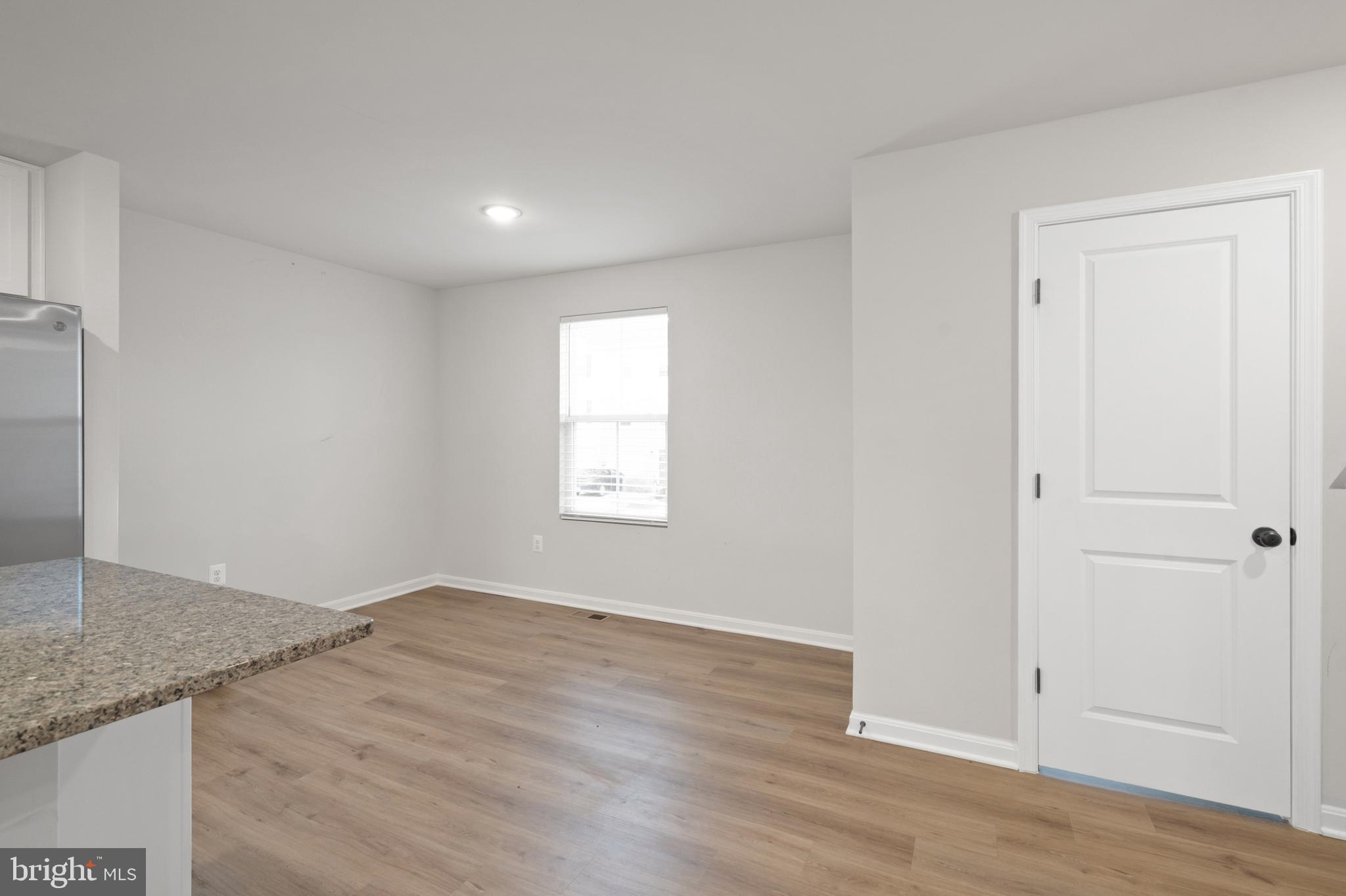 51 Thrower Road Hedgesville, WV 25427 - Photo 17 of 38 an empty room with wooden floor and windows