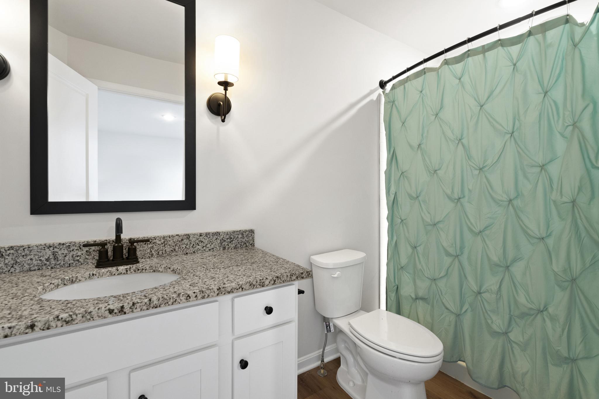 51 Thrower Road Hedgesville, WV 25427 - Photo 24 of 38 a bathroom with a granite countertop sink and a mirror