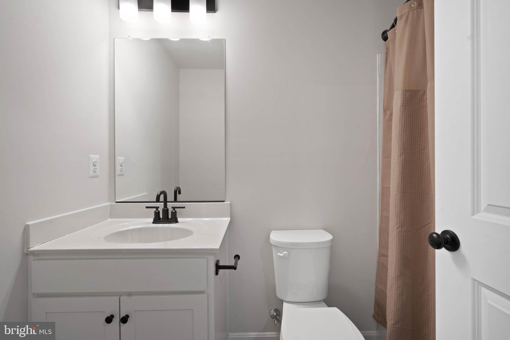 51 Thrower Road Hedgesville, WV 25427 - Photo 30 of 38 a bathroom with a sink a toilet and mirror