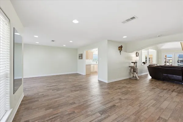 a view of a kitchen with furniture and wooden floor