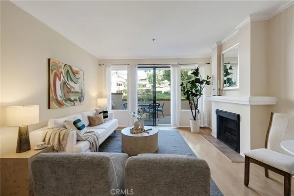 a living room with furniture fireplace and window