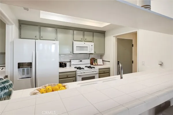 a kitchen with stainless steel appliances a refrigerator and a stove