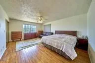 a spacious bathroom with a sink a toilet a mirror and bathtub