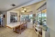 a room with lots of wooden furniture and a potted plant