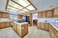 a kitchen with stainless steel appliances granite countertop a refrigerator and a stove