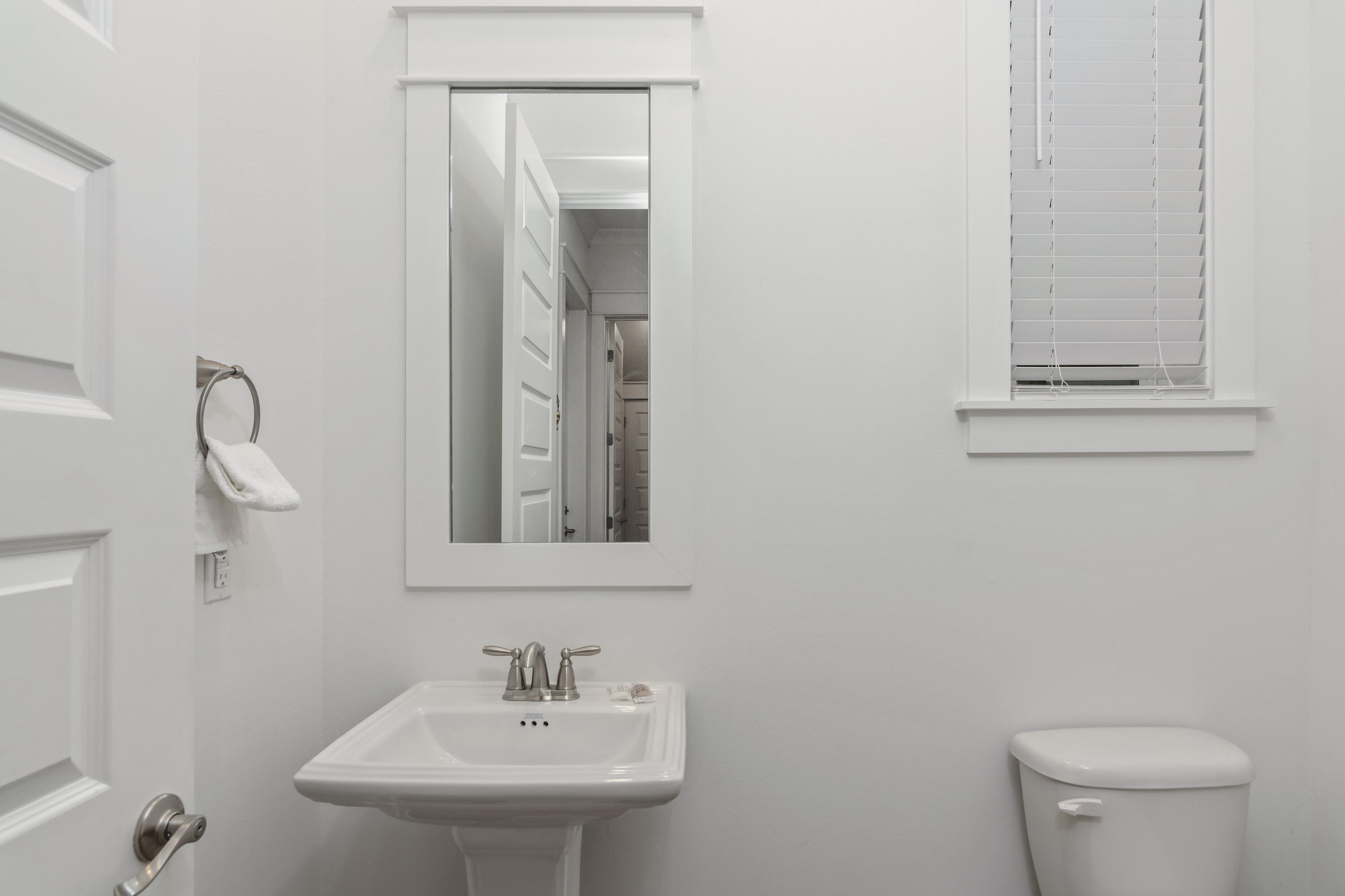 259 Milestone Dr Inlet Beach, Unit A Inlet Beach, FL 32461 - Photo 13 of 31 a bathroom with a toilet a sink and mirror
