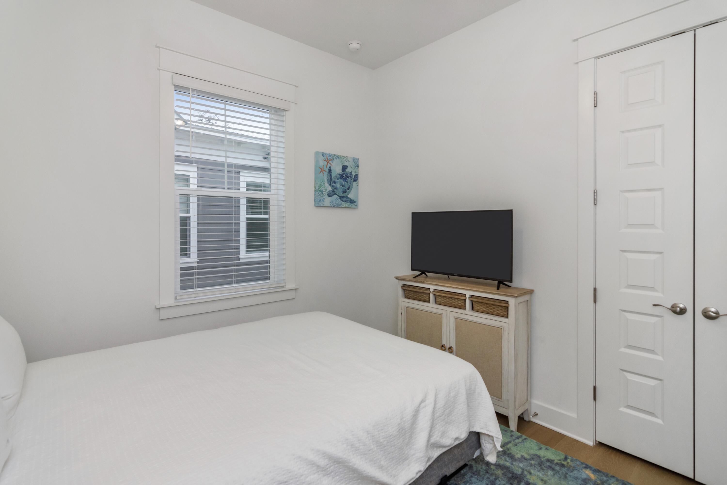 259 Milestone Dr Inlet Beach, Unit A Inlet Beach, FL 32461 - Photo 16 of 31 a bedroom with a bed and a flat screen tv