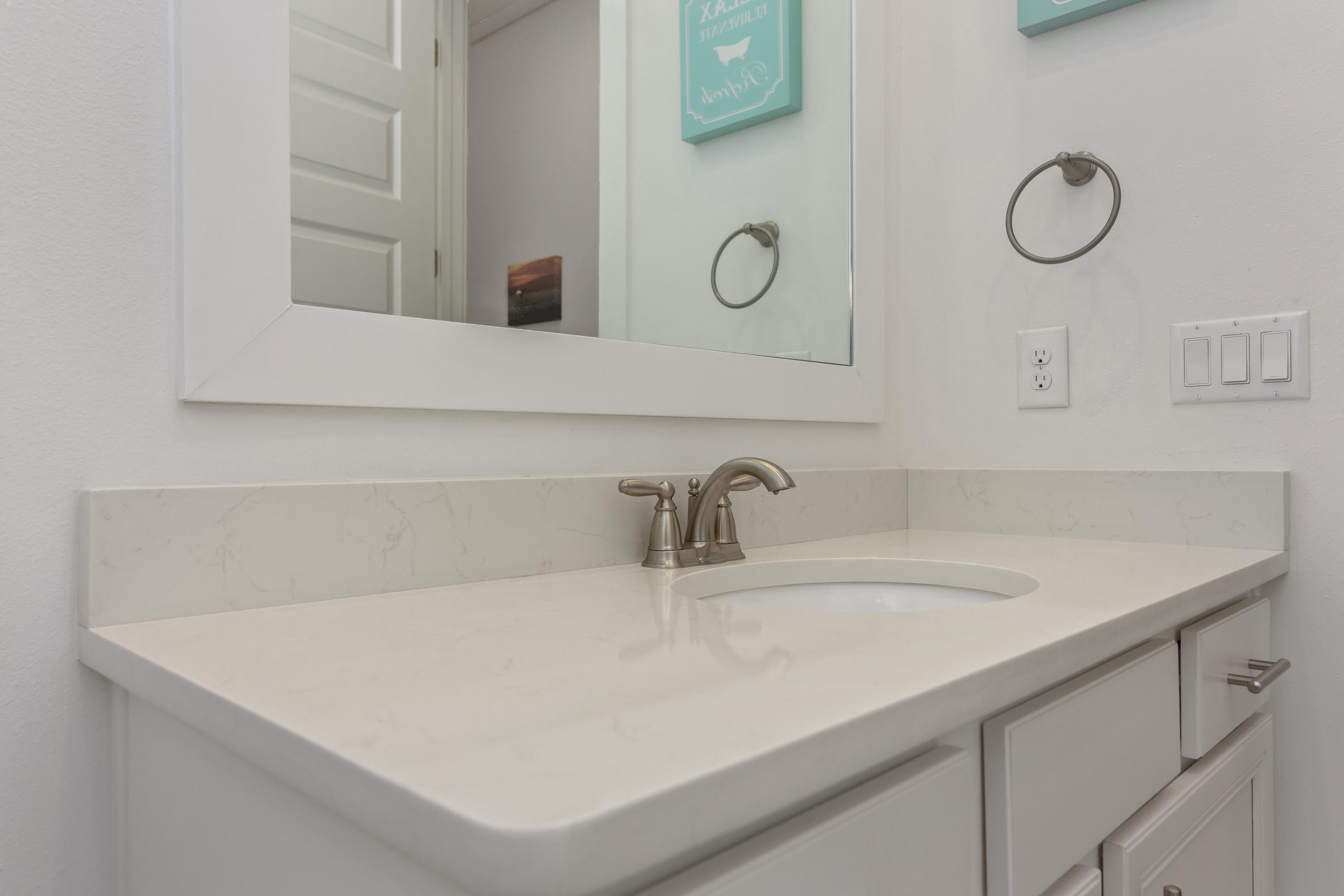 259 Milestone Dr Inlet Beach, Unit A Inlet Beach, FL 32461 - Photo 22 of 31 a bathroom with a sink and a mirror