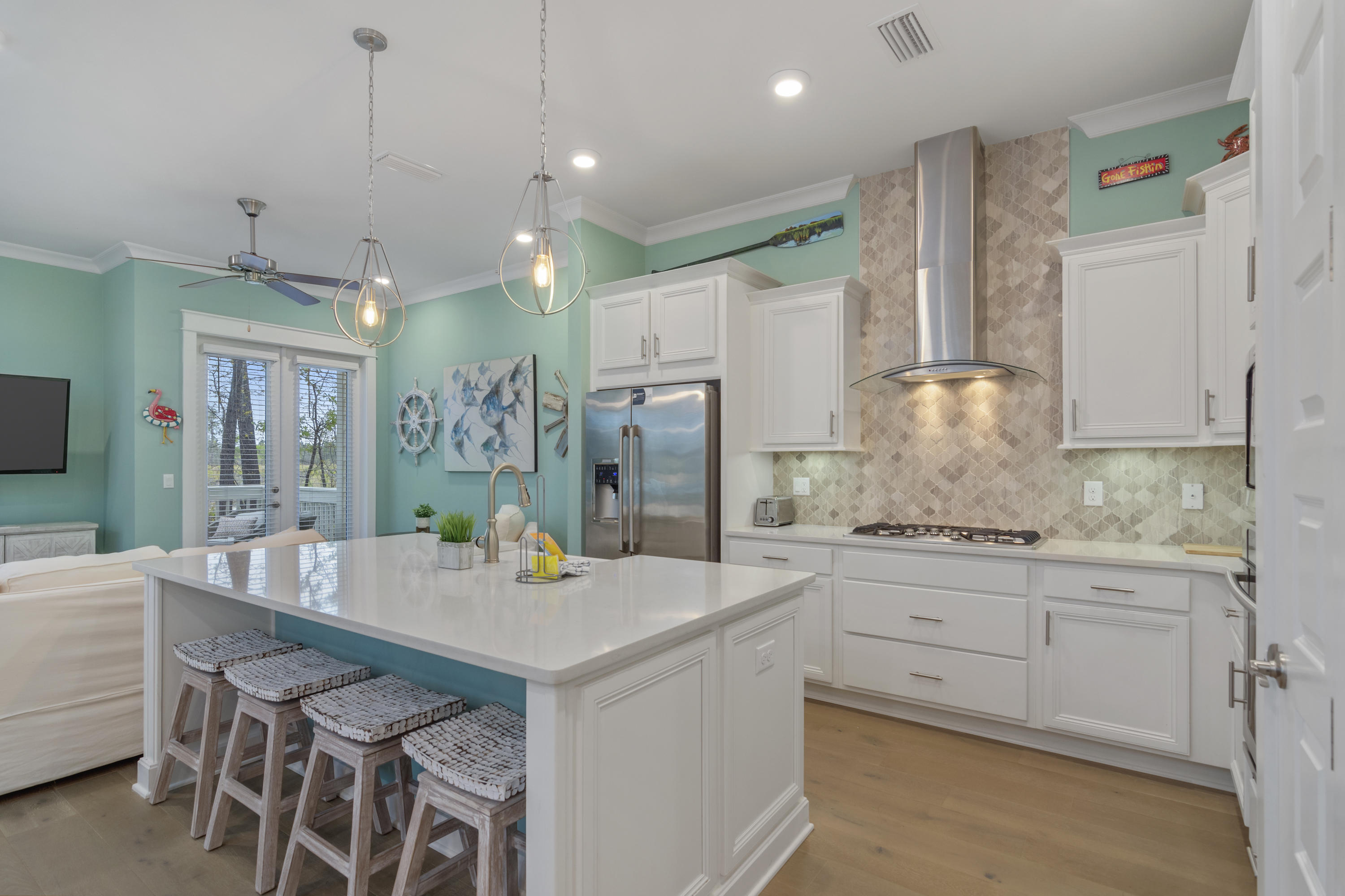 259 Milestone Dr Inlet Beach, Unit A Inlet Beach, FL 32461 - Photo 7 of 31 a kitchen with kitchen island granite countertop a sink a center island and cabinets