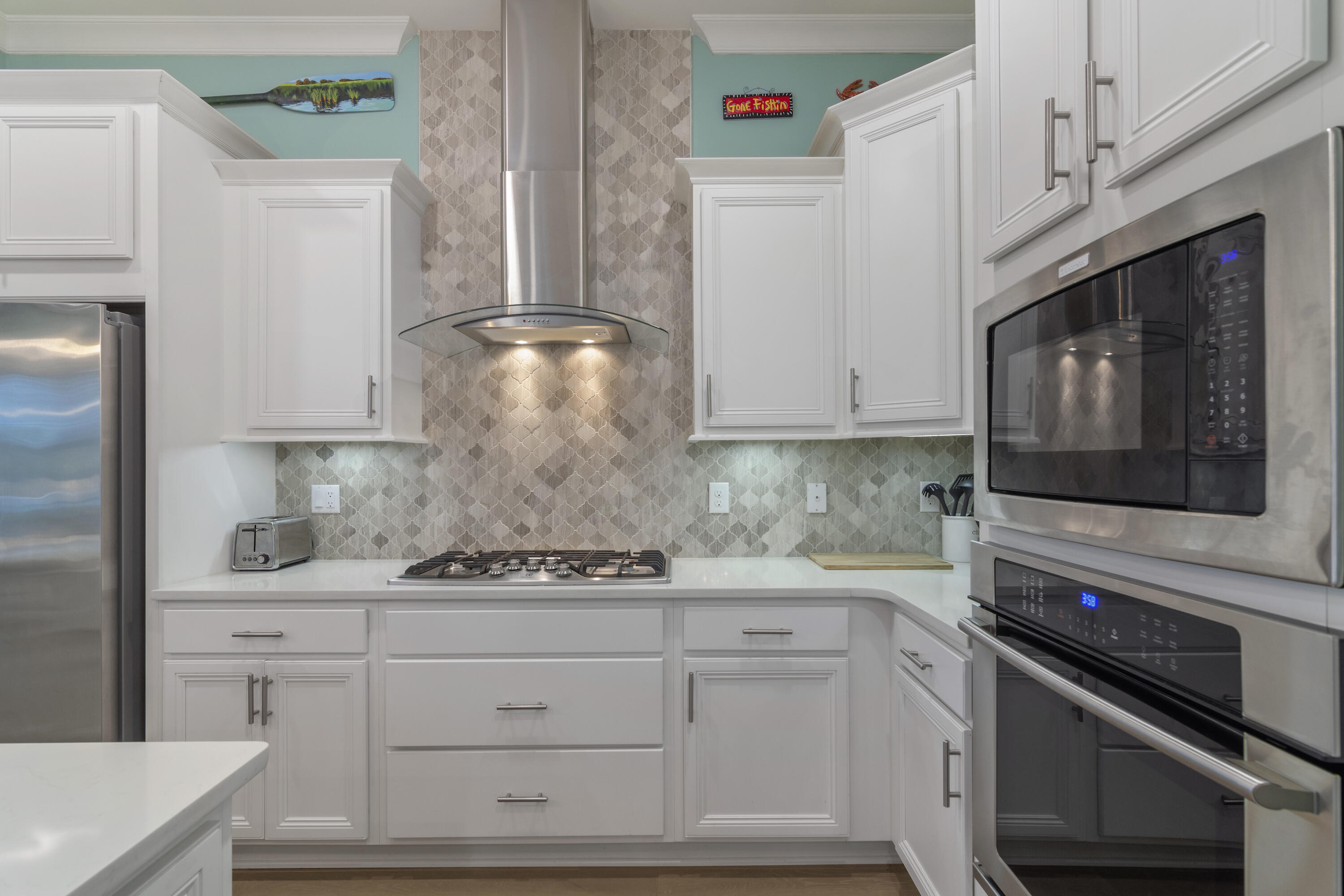 259 Milestone Dr Inlet Beach, Unit A Inlet Beach, FL 32461 - Photo 8 of 31 a kitchen with white cabinets and appliances