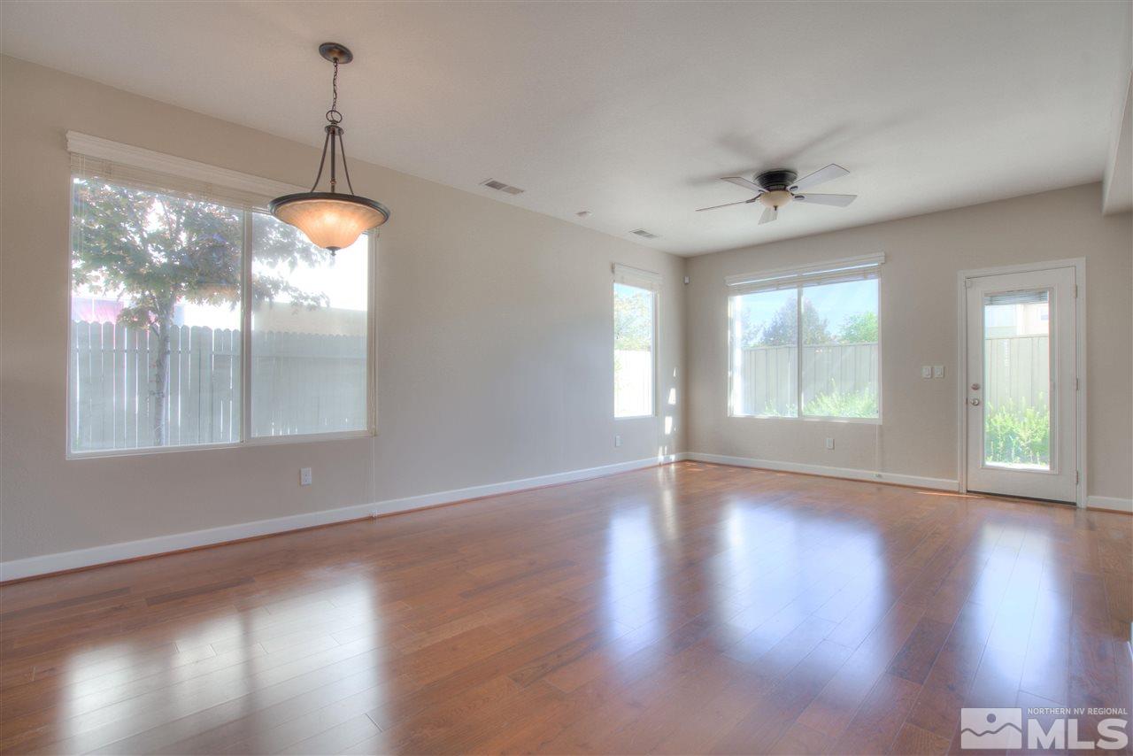10490 Chadwell Drive Reno, NV 89521 - Photo 8 of 36 a view of an empty room with wooden floor and a window