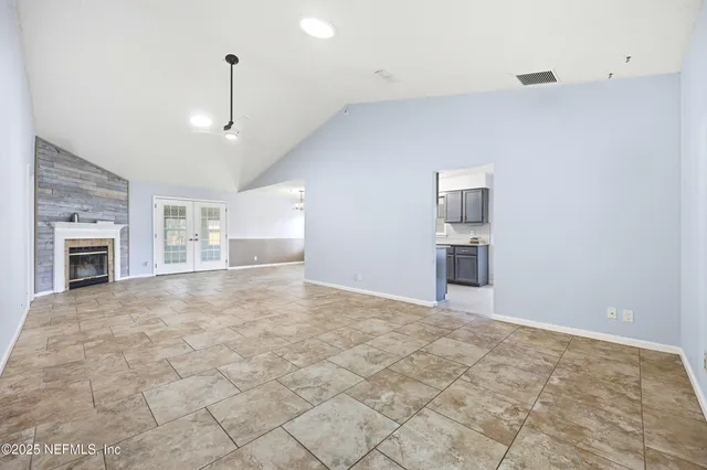 a view of empty room with a fireplace and cabinet