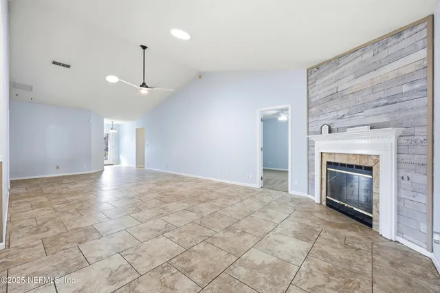 a view of an empty room with a fireplace