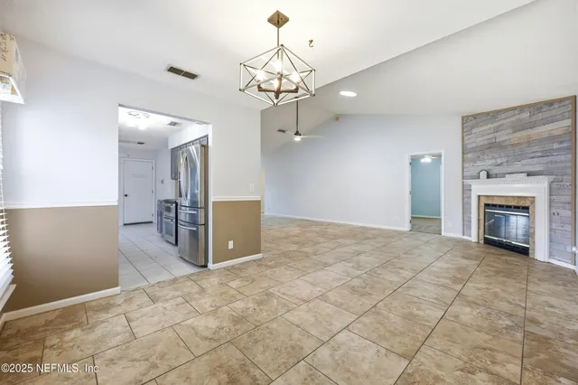 a view of a kitchen with a sink and a chandelier