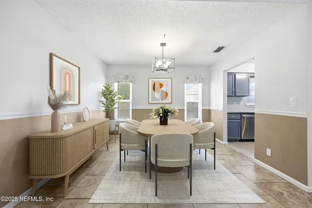 a view of a dining room with furniture and window