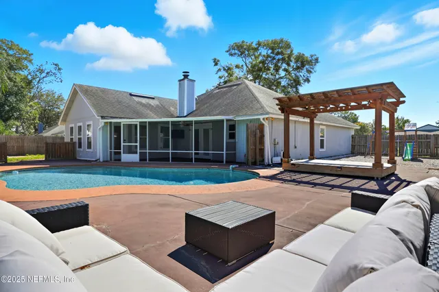 a view of a house with backyard and sitting area