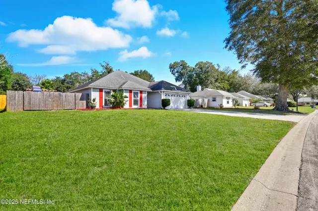 a house view with swimming pool and garden space