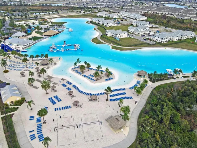 a kitchen that has a sink and a stove with white cabinets