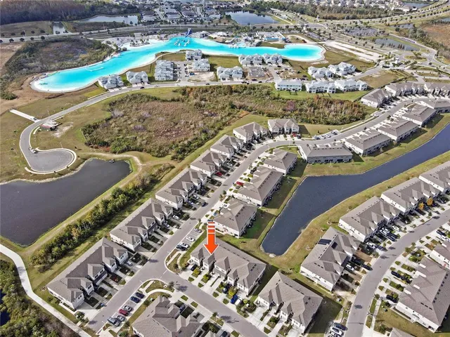 a living room with furniture and a flat screen tv with kitchen view