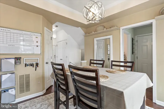 a view of a dining room with furniture and a chandelier