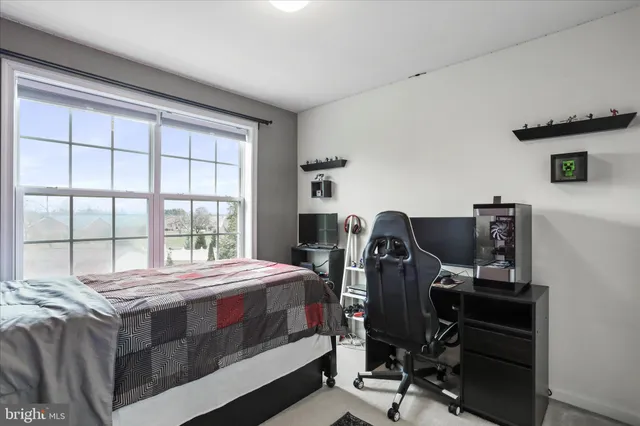 a bedroom with a bed and a desk