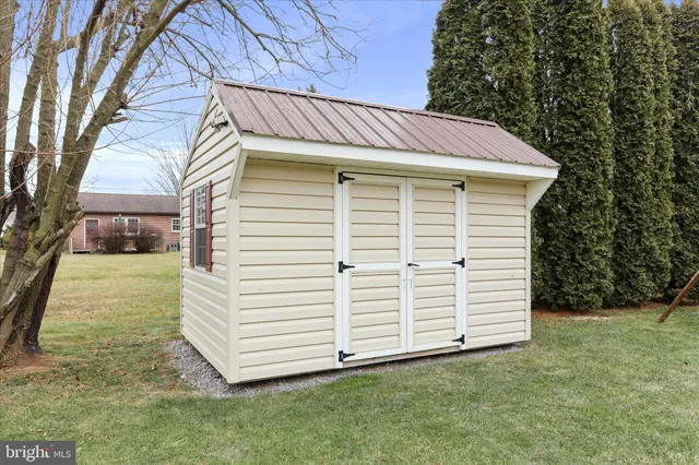a view of a white house with a yard