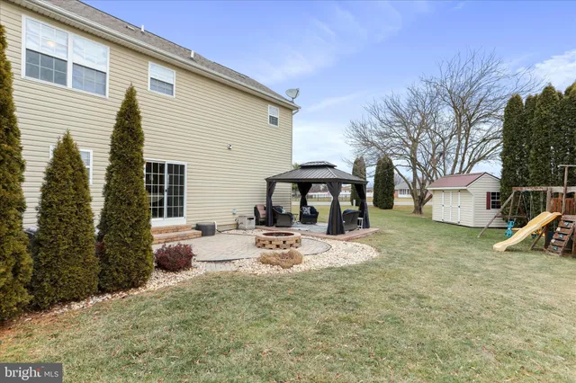 a view of a house with backyard and sitting area