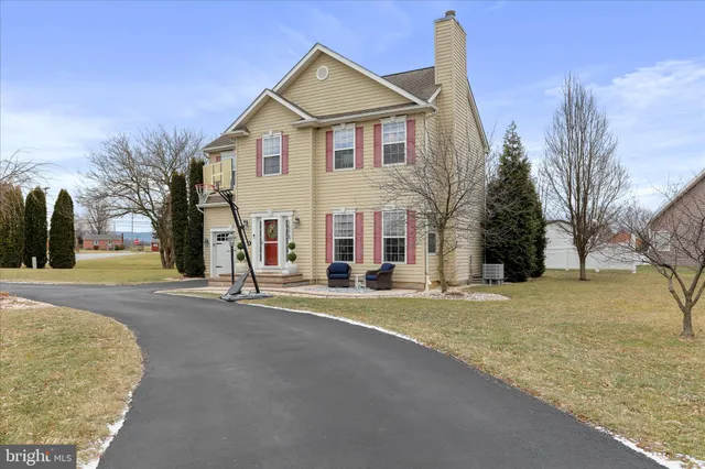 a view of a house with a snow on the road