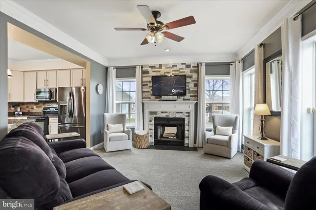 a living room with furniture a fireplace and a flat screen tv