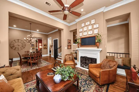 a living room with furniture a fireplace and a flat screen tv