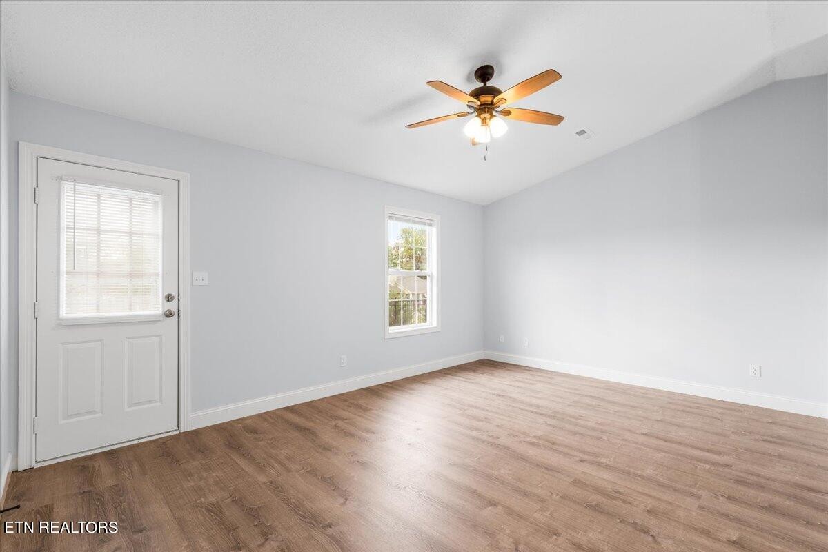 731 High Point Way, Knoxville, TN 37912 - Photo 16 of 25 a view of an empty room with wooden floor and a window