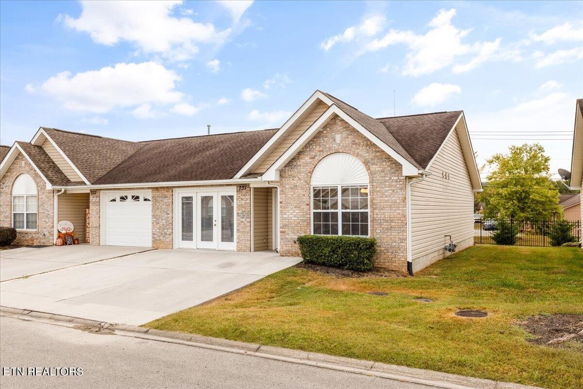 731 High Point Way, Knoxville, TN 37912 - Photo 2 of 25 a view of a white house next to a yard with potted plants
