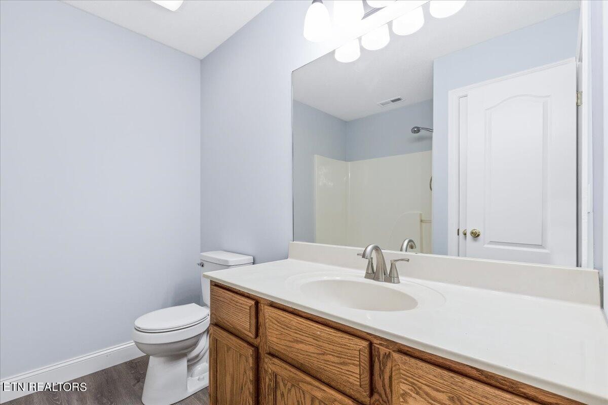 731 High Point Way, Knoxville, TN 37912 - Photo 21 of 25 a bathroom with a sink a toilet and a mirror