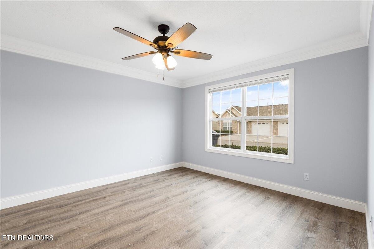 731 High Point Way, Knoxville, TN 37912 - Photo 5 of 25 a view of an empty room with wooden floor and a window