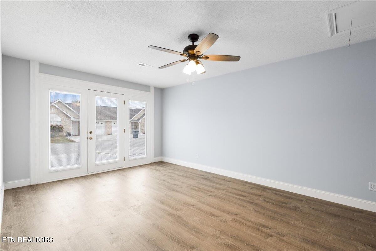 731 High Point Way, Knoxville, TN 37912 - Photo 8 of 25 a view of an empty room with window and wooden floor